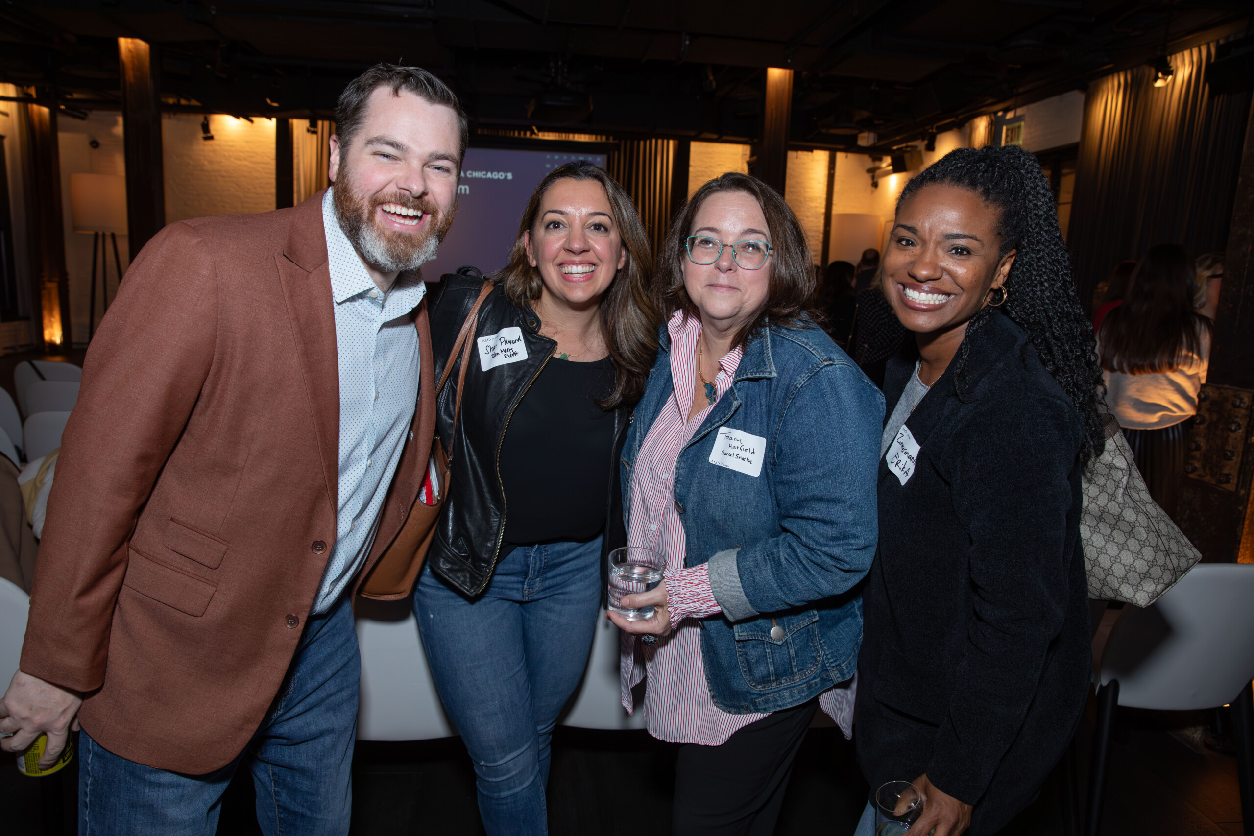 photo of four people posing for a photo together at the 2024 CMO Forum
