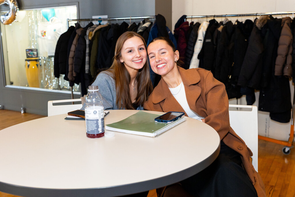 Photo of two students at 2025 Marketing Boot Camp; both smiling and leaning toward one another