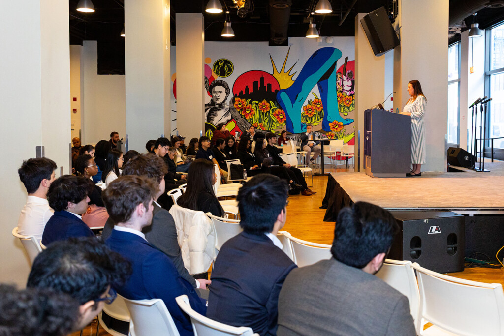 Establishing photo showing the audience of students and a speaker on stage at 2025 Marketing Boot Camp