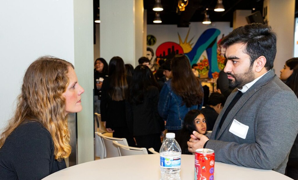 Photo of 2 people talking intently at an AMA Chicago student boot camp event